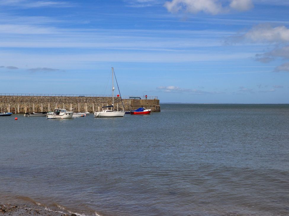 Boats in the water near a pier at Riverside Cottage in Caernarfon