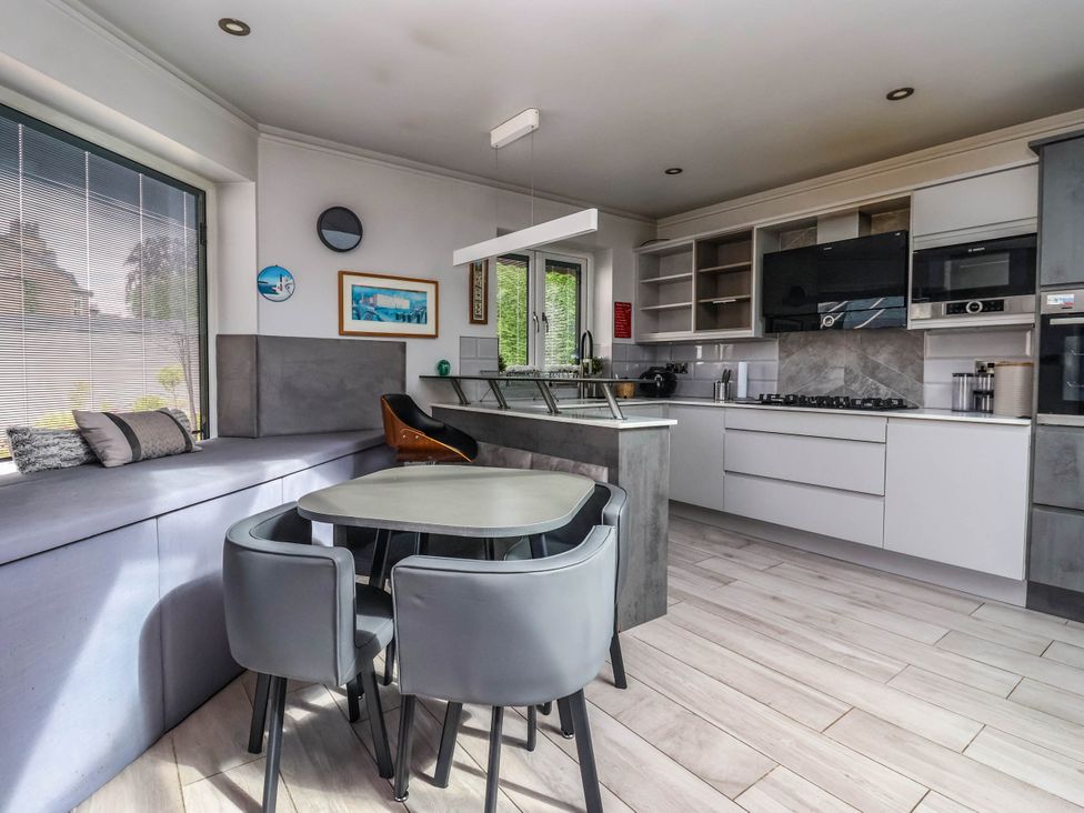 A kitchen with a dining table and chairs at The Annexe in Shipley