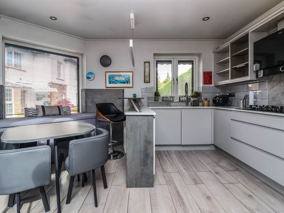 A kitchen with seating area and appliances at The Annexe Shipley