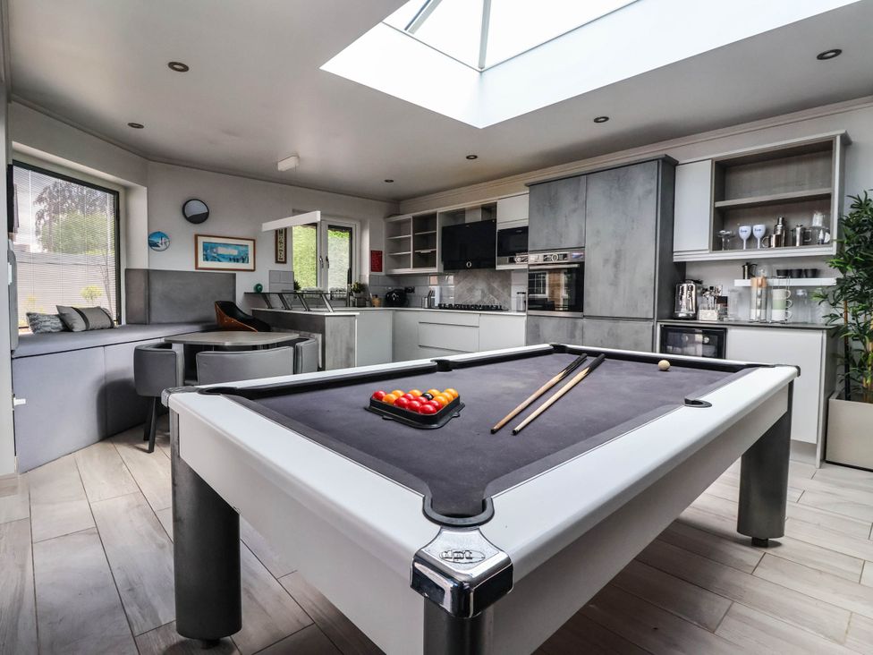 A game room with a pool table and kitchen cabinets at The Annexe in Shipley