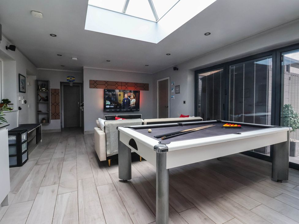 A room with a pool table and sofa at The Annexe in Shipley