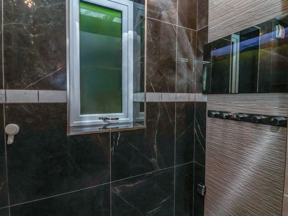 A bathroom with a window and shower panel at The Annexe in Shipley