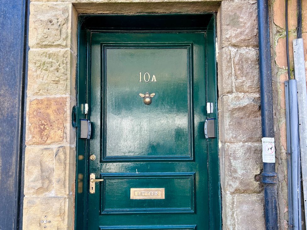A green door with number 10A and a letterbox at Downton II, Alnwick