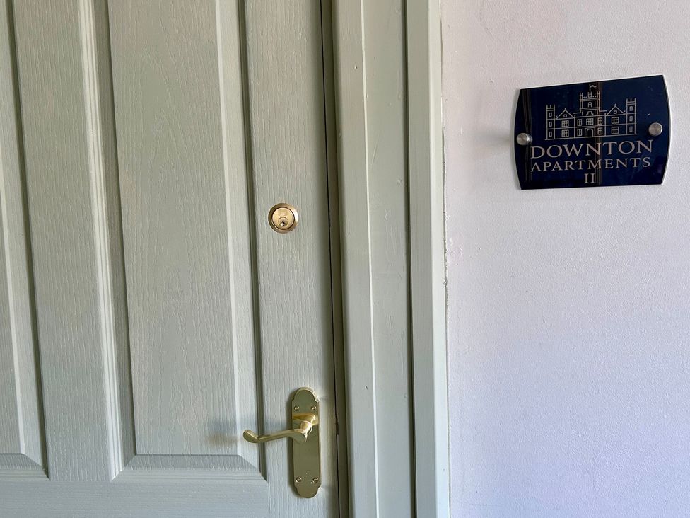 A door with a nameplate indicating Downton Apartments II in Alnwick
