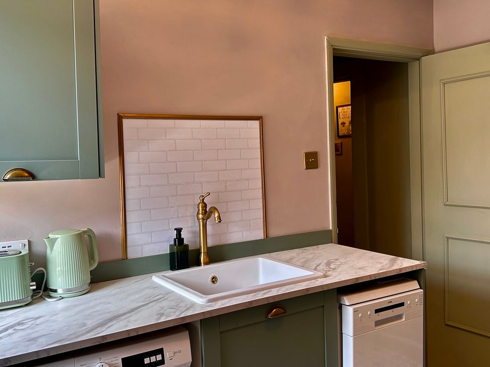 A kitchen with sink, cabinets, and dishwasher at Downton II in Alnwick
