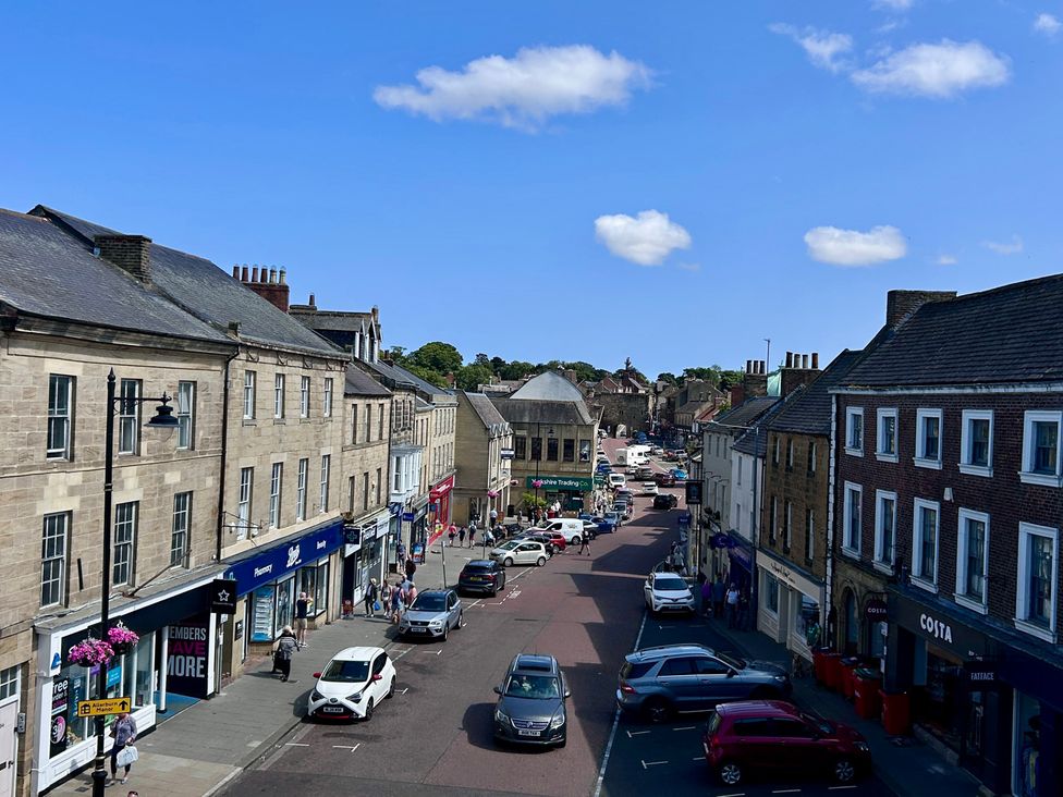 A street view with shops and cars at Downton II in Alnwick
