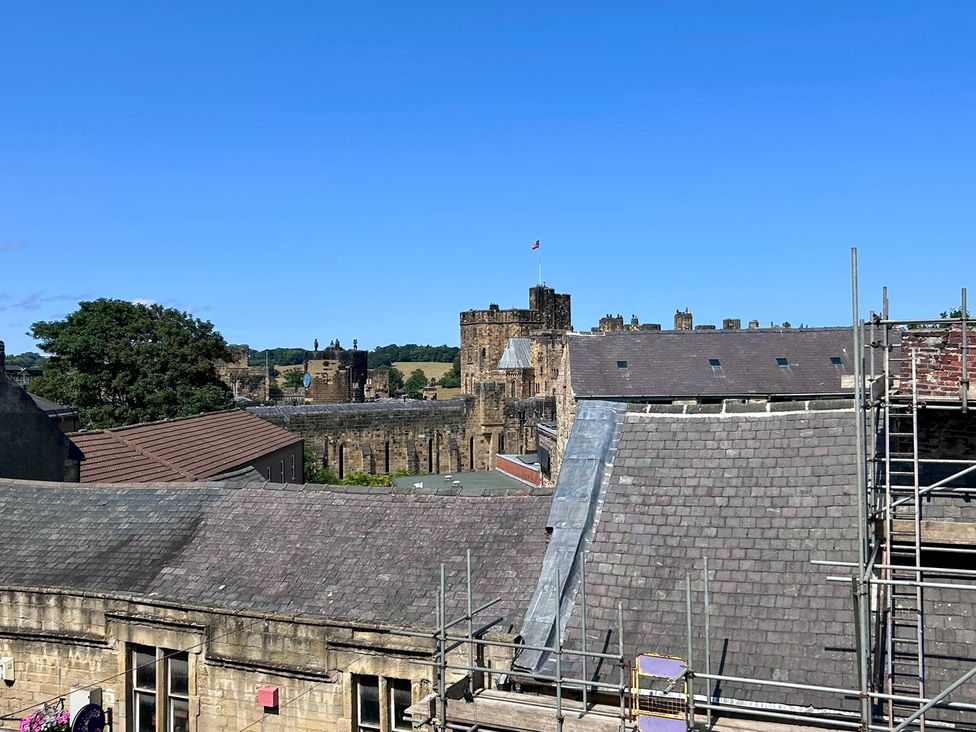 A view of a castle and rooftops at Downton II in Alnwick
