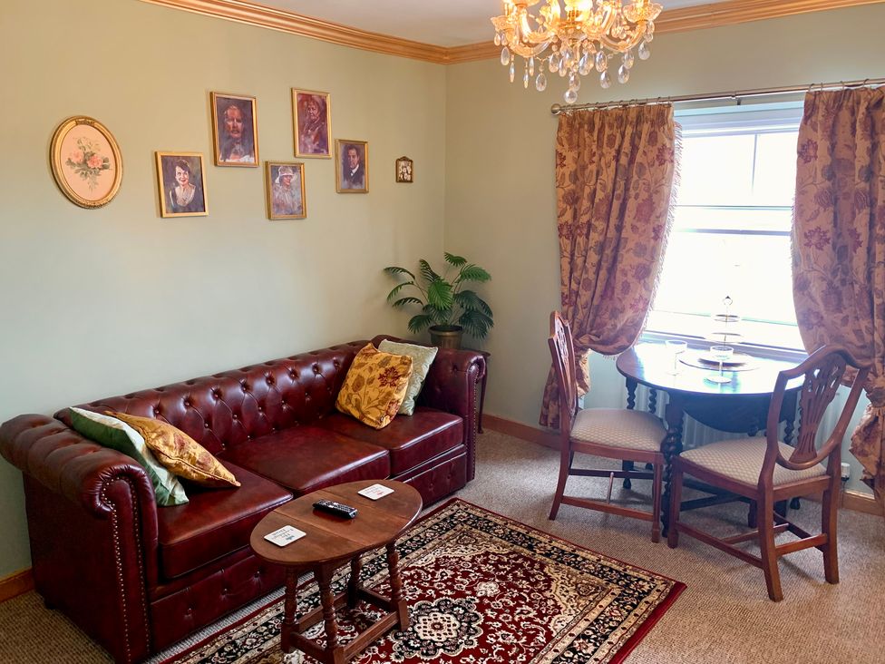 A living room with a sofa and table at Downton II in Alnwick