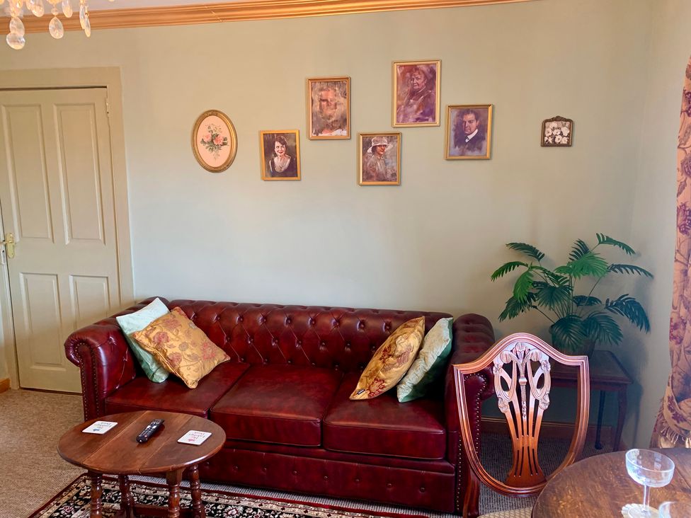 A living room with a couch and wall art at Downton II in Alnwick