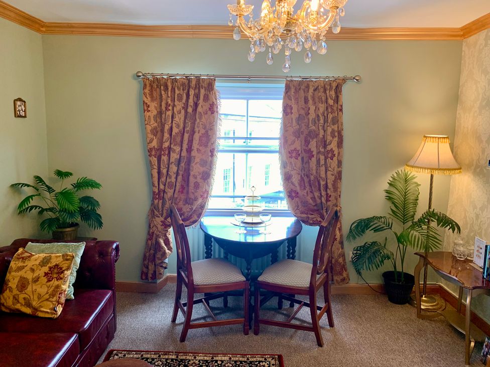 A dining area with a table and chairs at Downton II in Alnwick