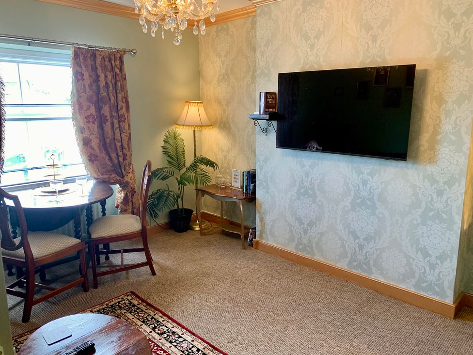A living room with a table and chairs at Downton II in Alnwick