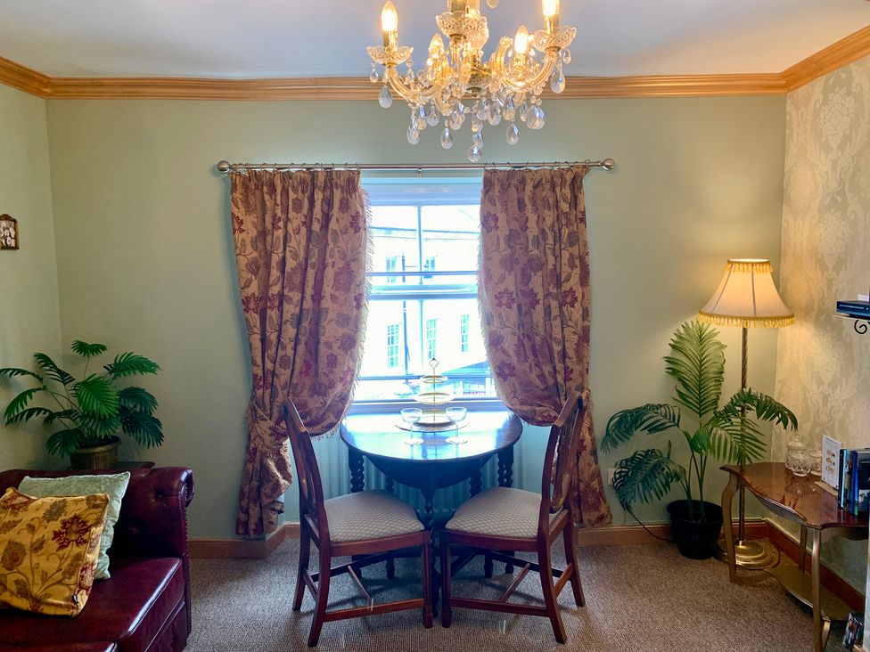 A dining area with a table and chairs at Downton II in Alnwick