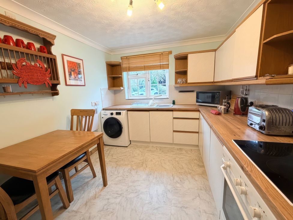 A kitchen with a table and chairs at No 1 The Martins in Walberswick