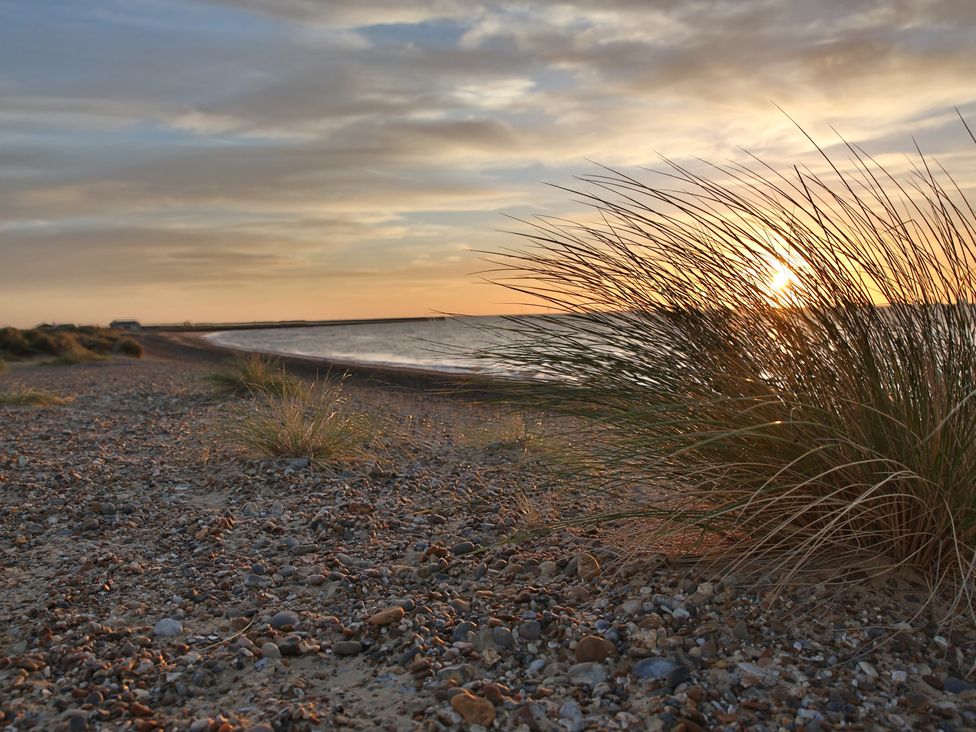 A beach with grass and pebbles at No 1 The Martins Walberswick