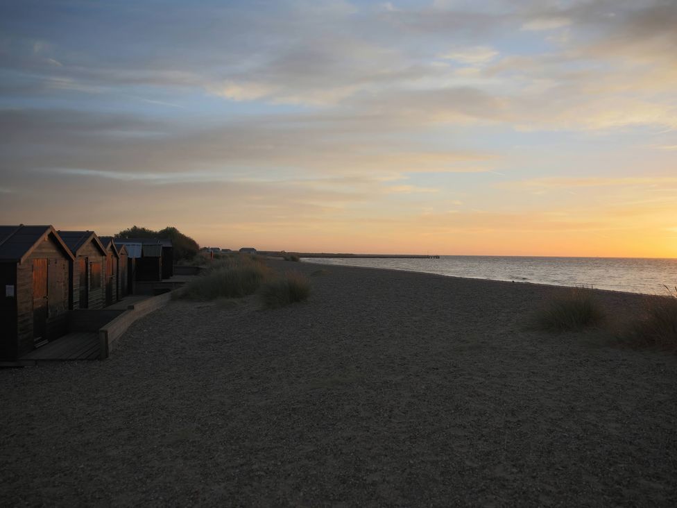 Beach huts along the shore during sunset at No 1 The Martins Walberswick