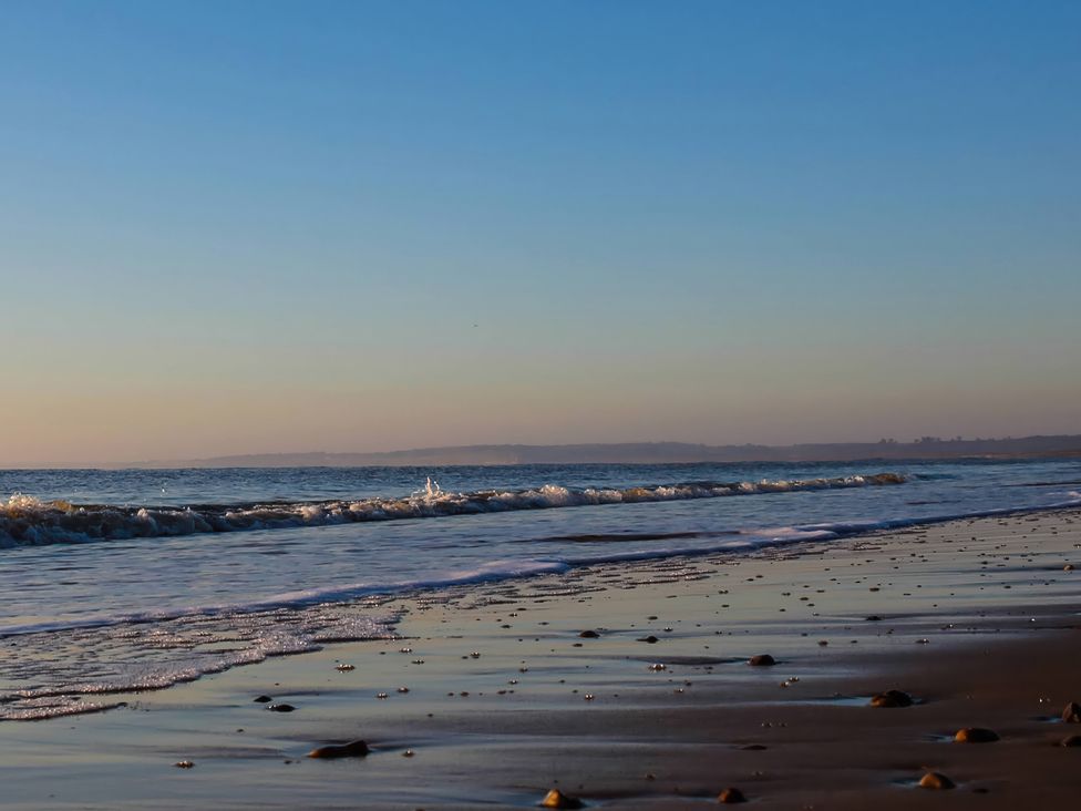 A beach scene with waves and sand at No 1 The Martins Walberswick