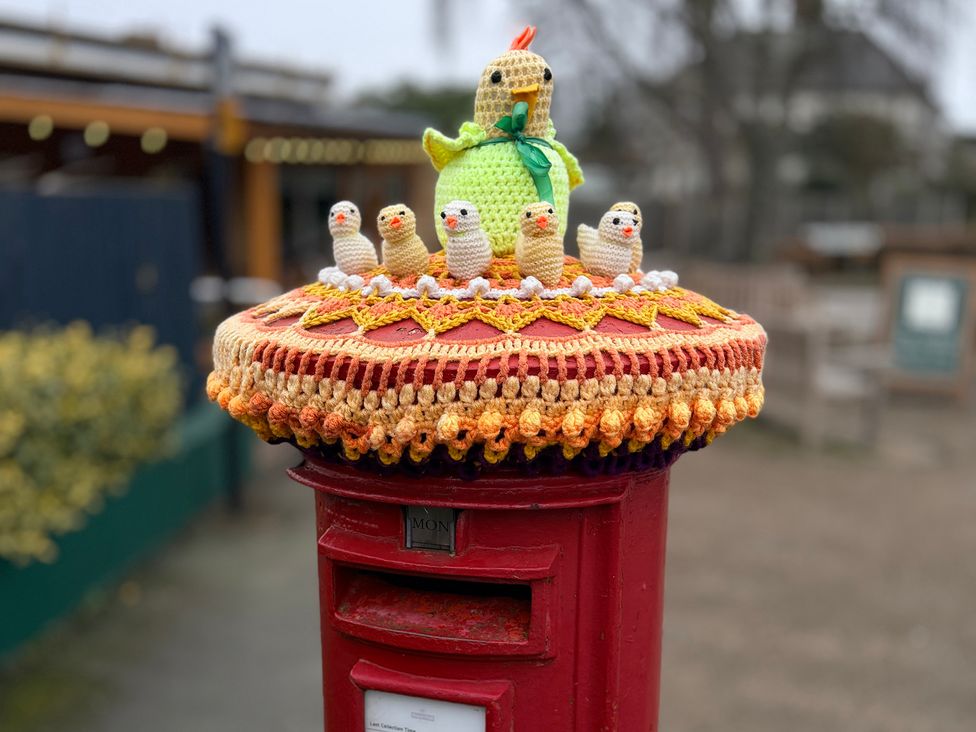 A post box with a crochet cover featuring birds at No 1 The Martins Walberswick