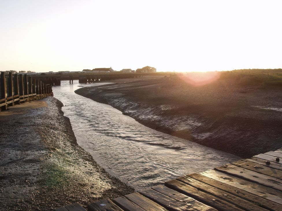 A waterway leading to a pier at No 1 The Martins Walberswick
