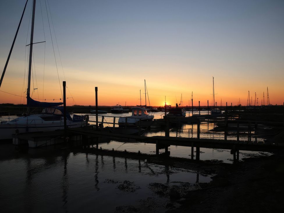 A marina with boats and a sunset at No 1 The Martins, Walberswick