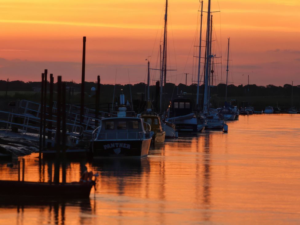 Boats docked at a pier during sunset at No 1 The Martins Walberswick