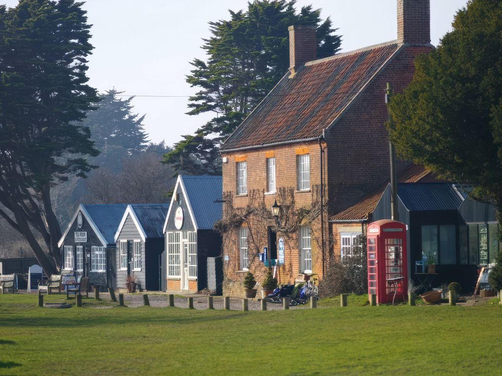 A house and telephone box in an outdoor area at No 1 The Martins Walberswick