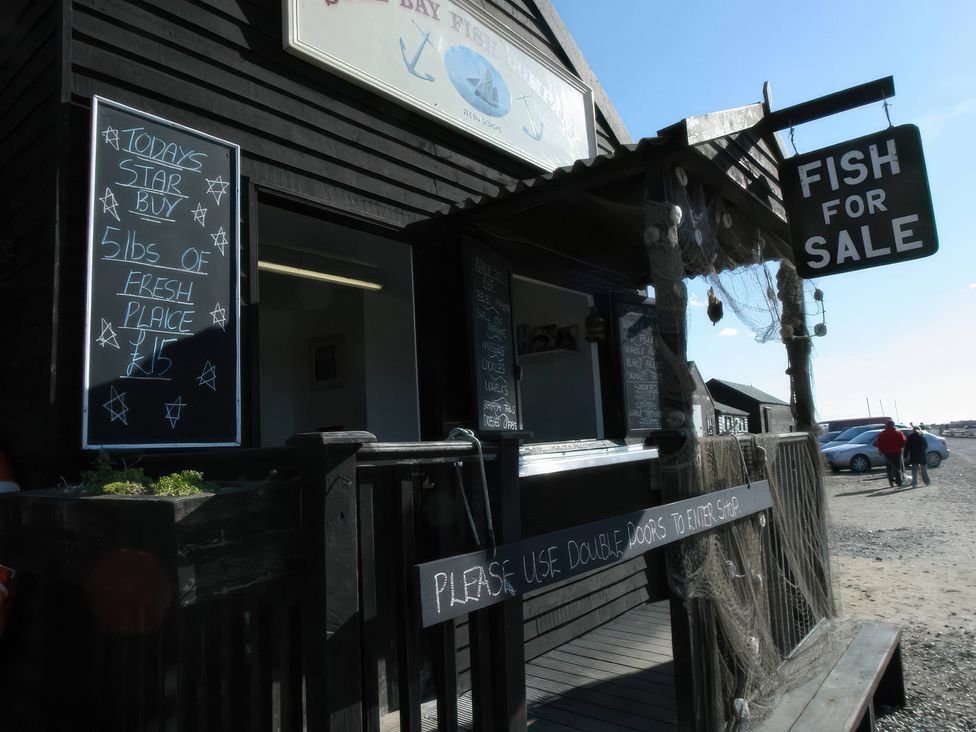 A fish shop with a sign for fresh fish for sale at No 1 The Martins Walberswick