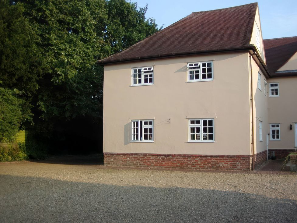 A house with multiple windows and a gravel driveway at No 1 The Martins Walberswick