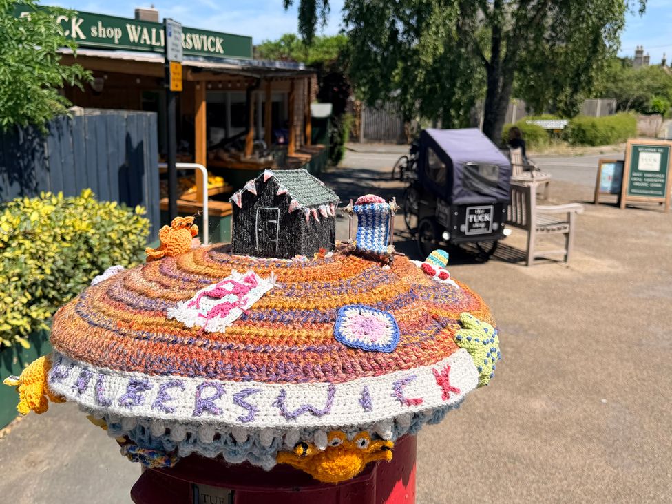 A decorated post box outside a shop at No 1 The Martins Walberswick