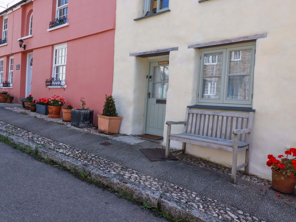 A bench and flower pots outside a house at Mary’s House
