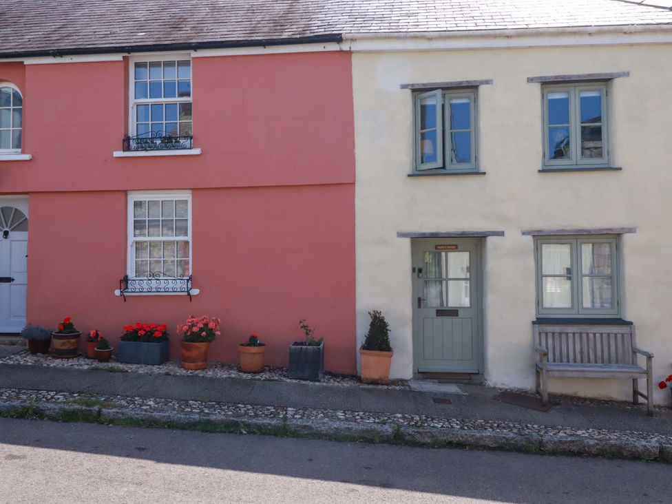 A pink and cream house with flower pots outside Mary’s House 