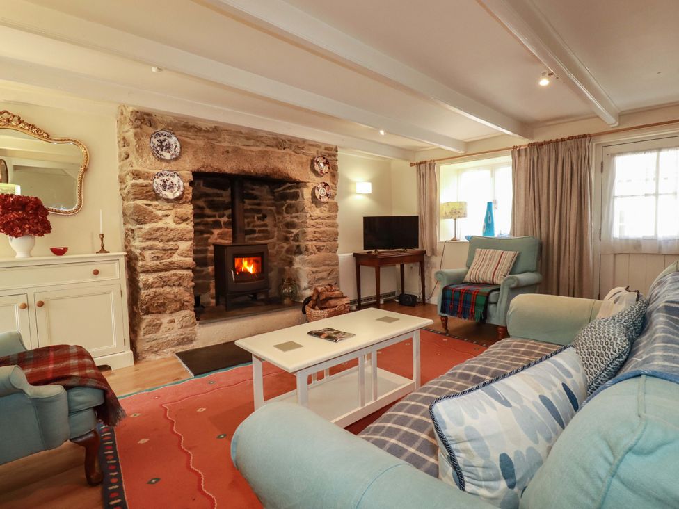 A living room with a fireplace and sofa at Mary’s House