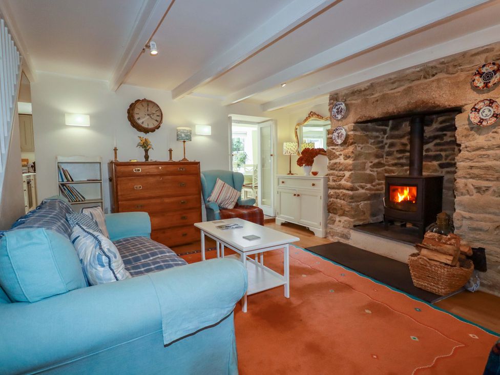 A living room with a fireplace and furniture at Mary’s House
