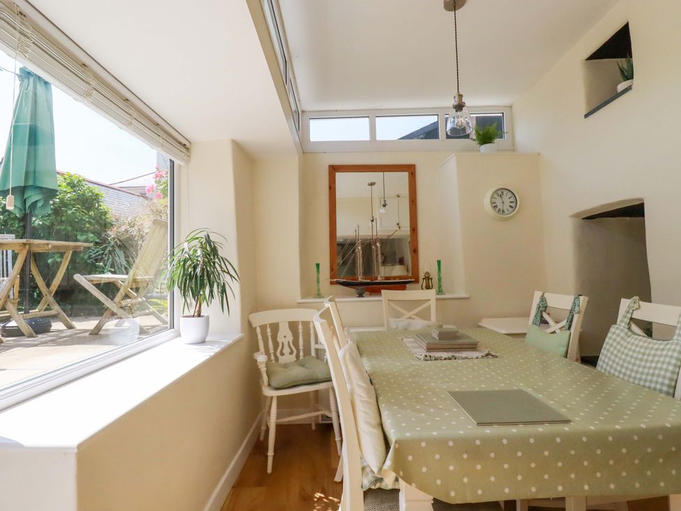 A dining room with a table and chairs at Mary’s House