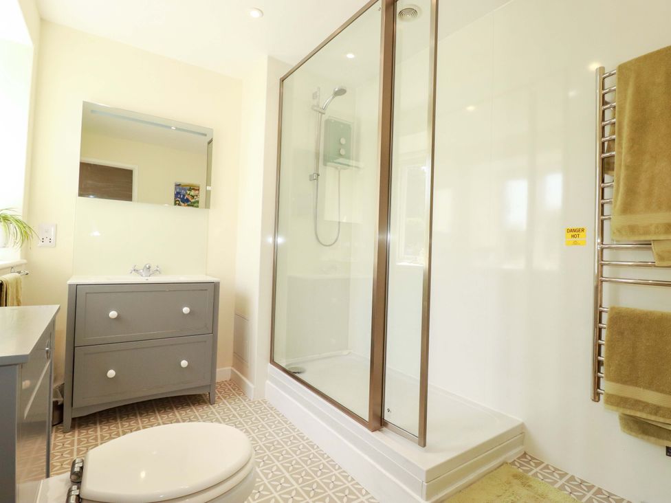 A bathroom with a shower and sink at Mary’s House