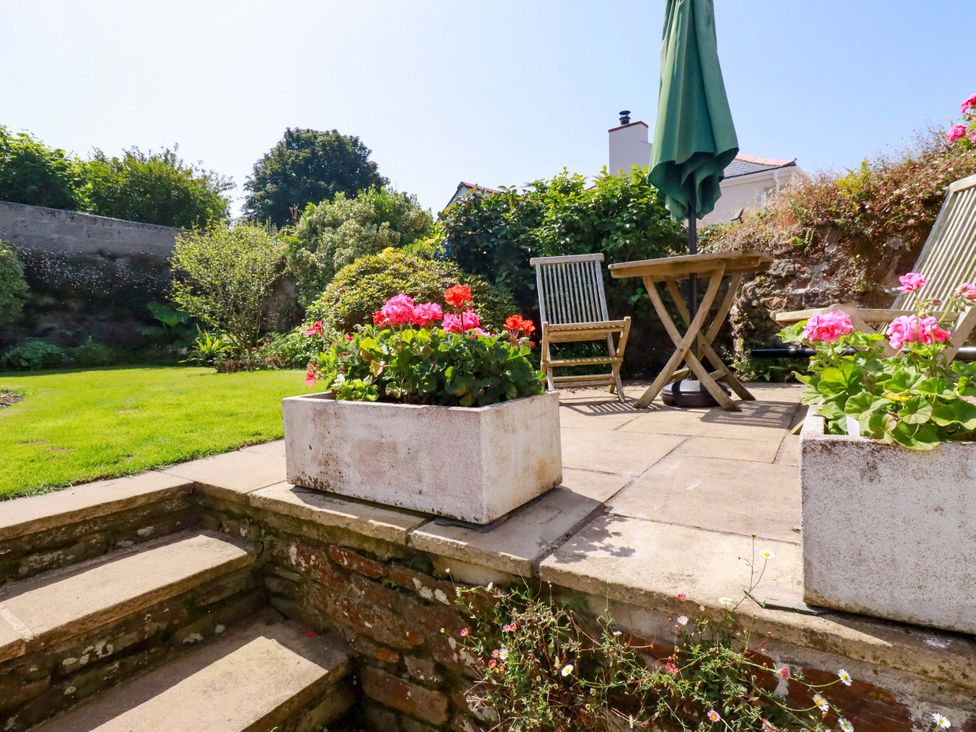 A garden with flowers and seating area at Mary’s House in 