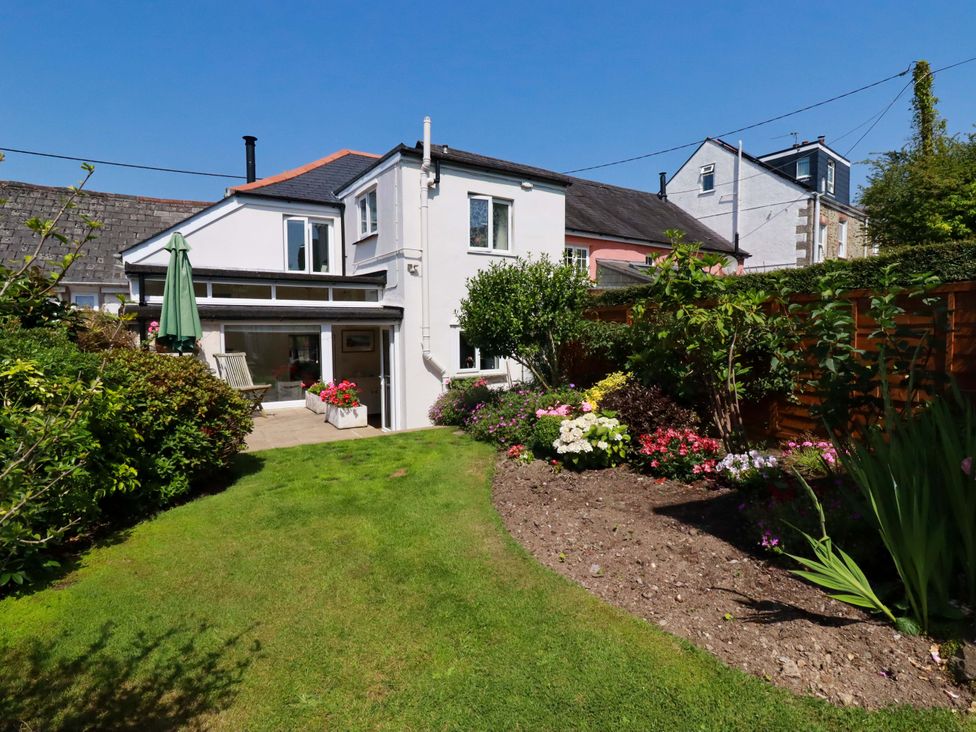 A house with a garden and flower beds at Mary’s House