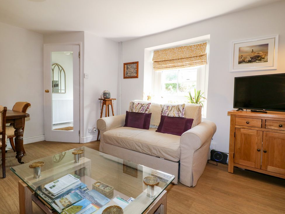 A living room with a sofa and television at Sunnyside in Elton