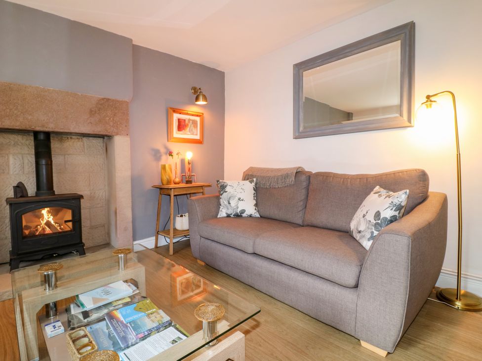 A living room with a sofa and fireplace at Sunnyside Elton