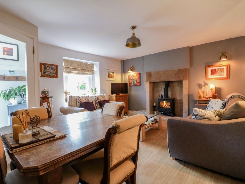 A living room with a fireplace and seating area at Sunnyside in Elton