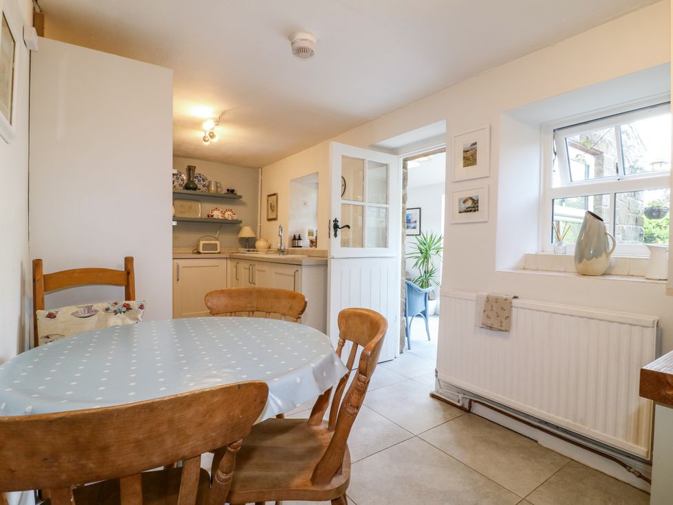 A kitchen with a table and chairs at Sunnyside in Elton