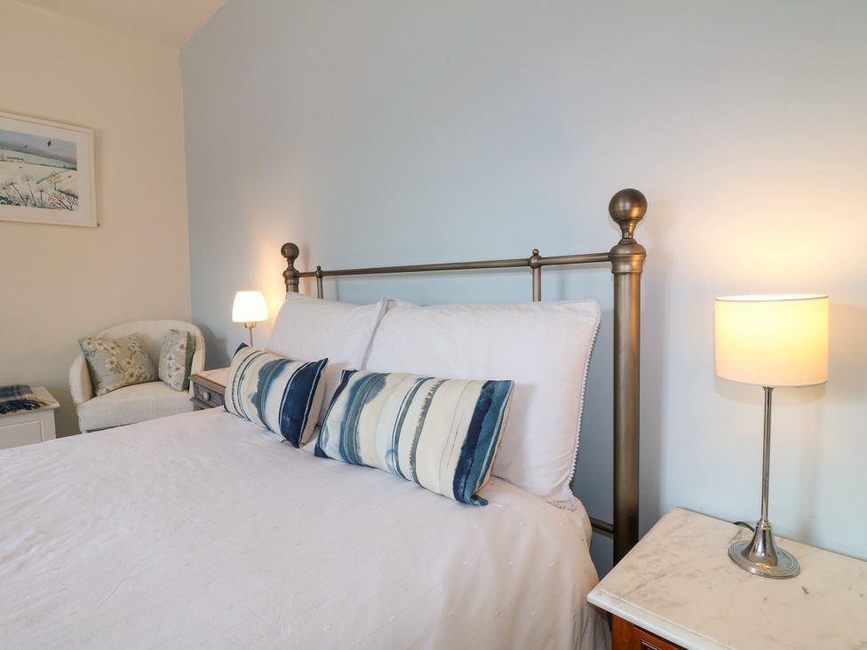 A bedroom with a bed and an armchair at Sunnyside in Elton