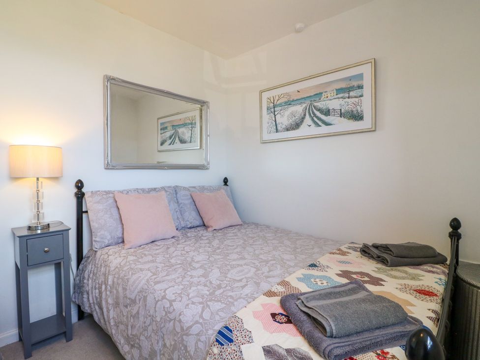 A bedroom with a bed and a bedside table at Sunnyside in Elton