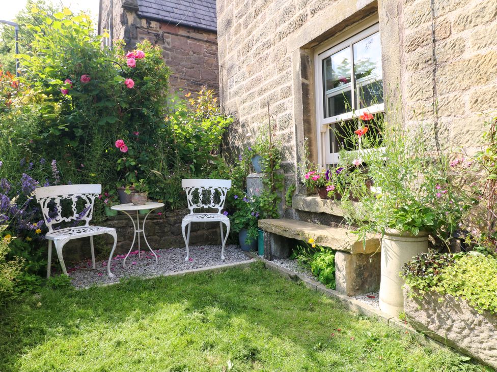 A garden with seating and flowers at Sunnyside in Elton