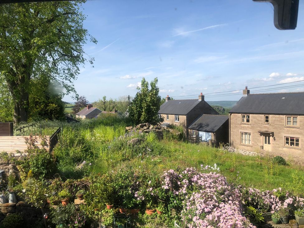 A view of houses and garden with trees at Sunnyside in Elton