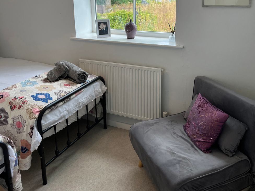 A bedroom with a bed and a chair at Sunnyside in Elton