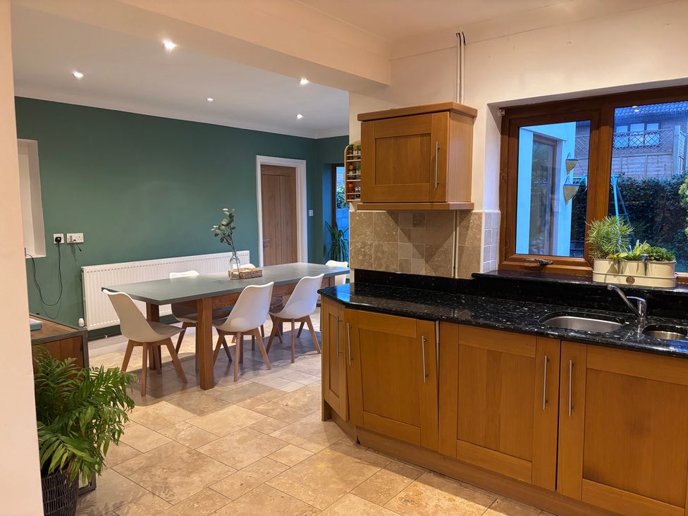 A kitchen with a dining table and chairs at 7 Adrian Close Porthcawl