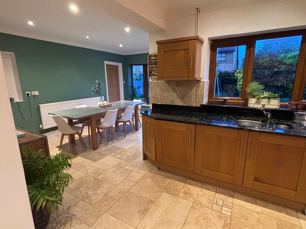 A kitchen with a dining table and chairs at 7 Adrian Close in Porthcawl