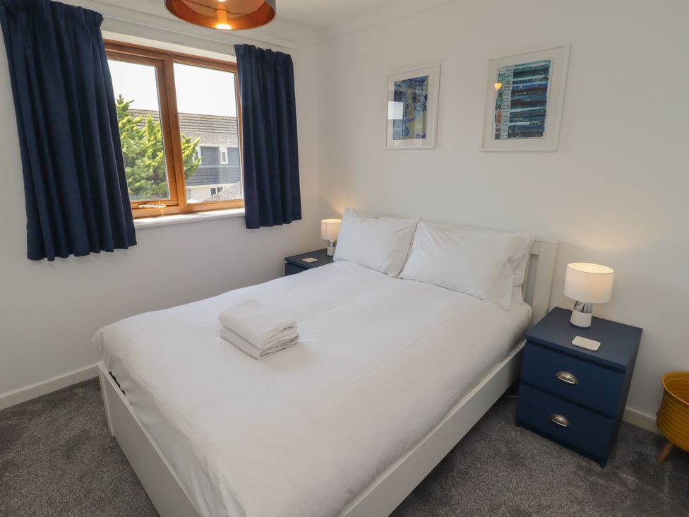 A bedroom with a double bed and bedside tables at Ty Traeth in Porthcawl