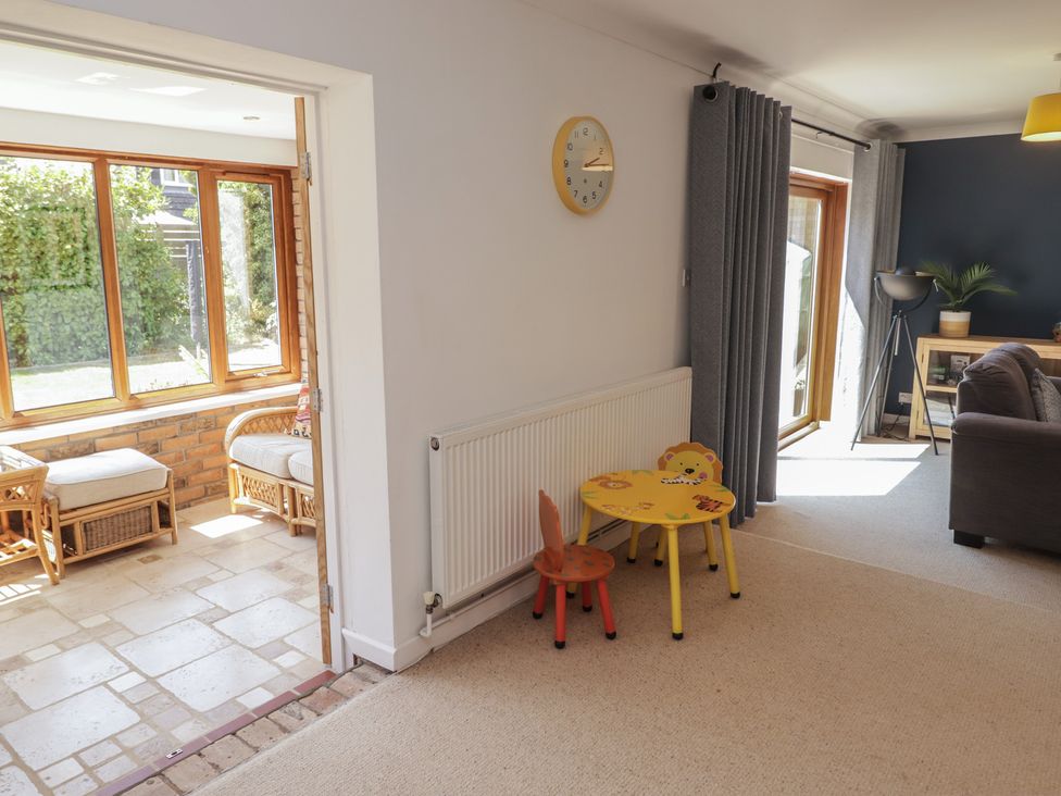 A living room with a sofa and a small table at Ty Traeth in Porthcawl