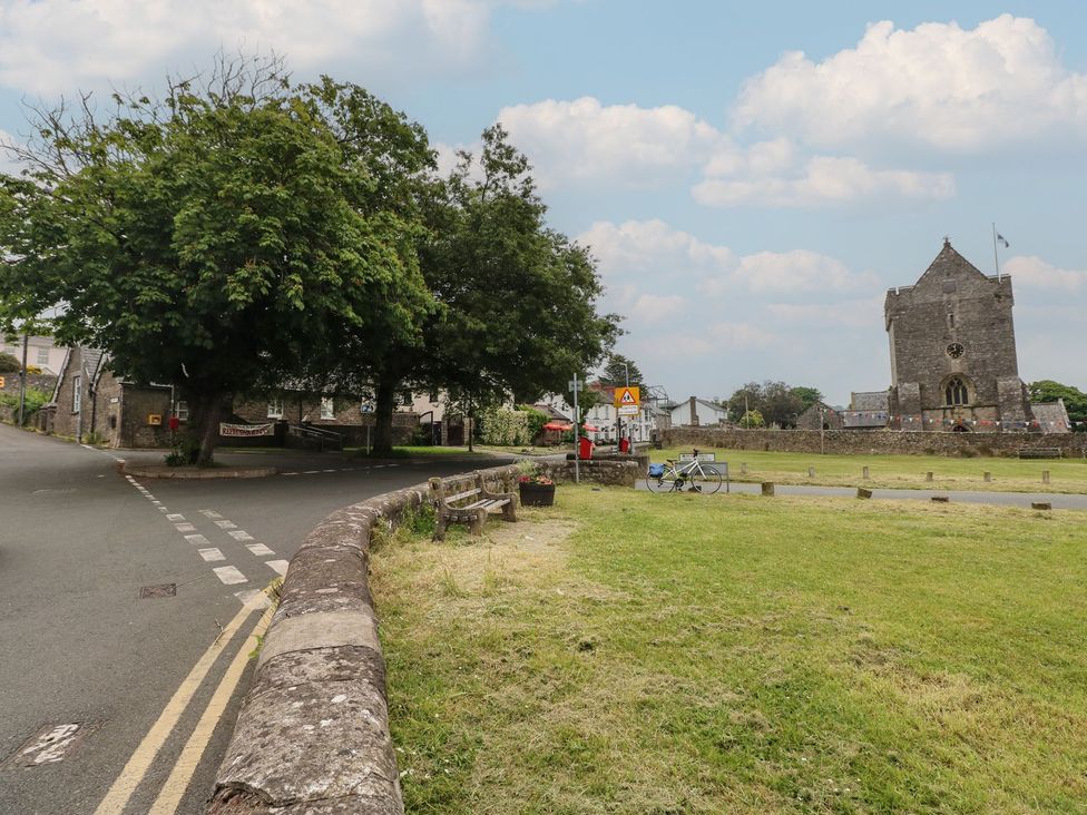 An outdoor area with a church and trees at Ty Traeth in Porthcawl